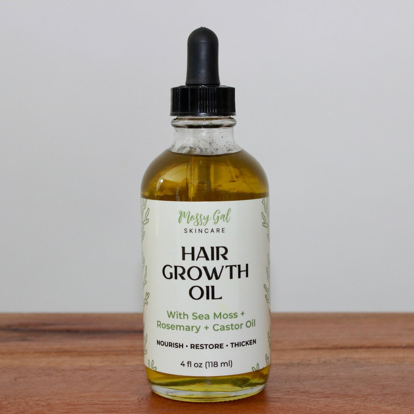 Mossy Gal Hair Growth Oil in glass dropper bottle.