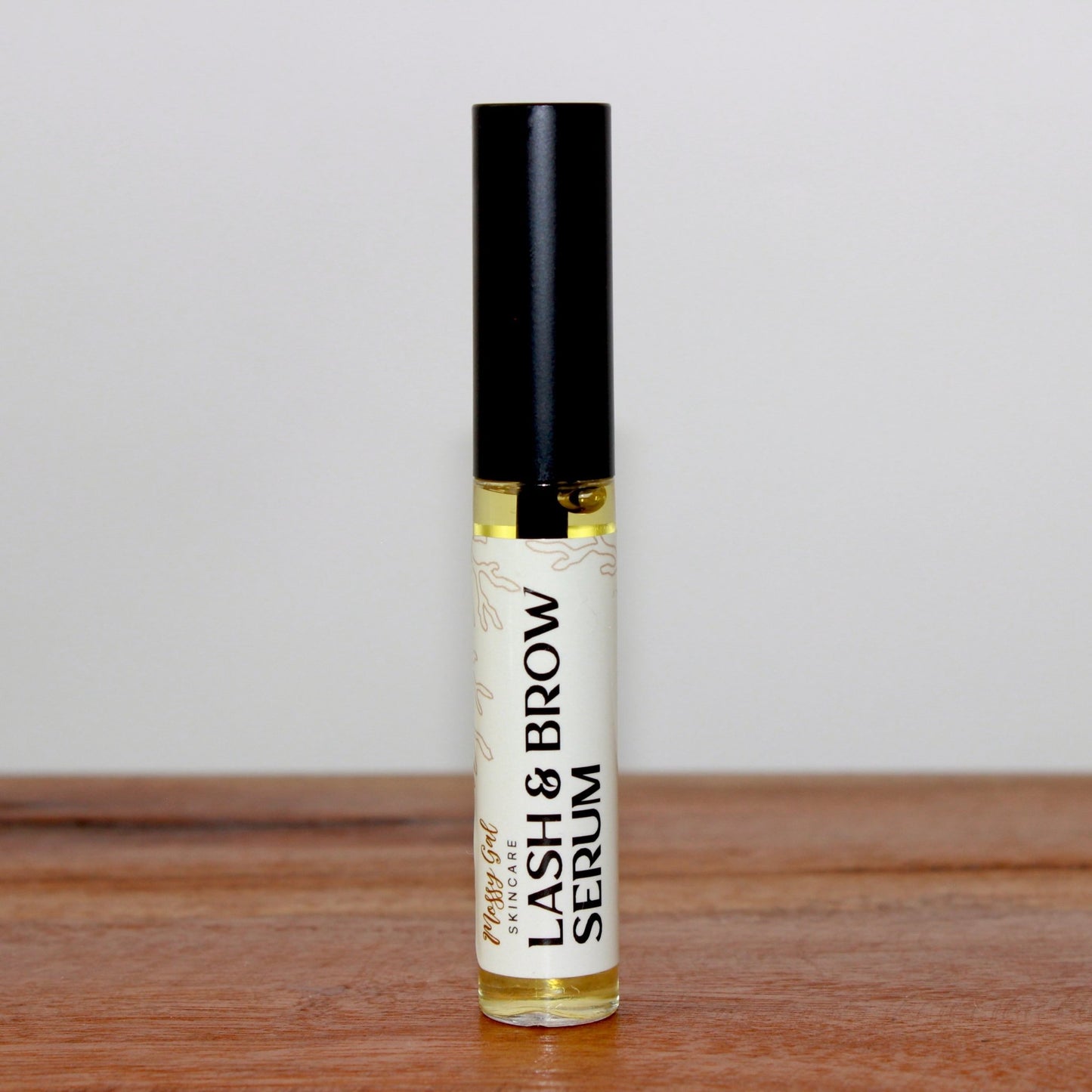 Mossy Gal Lash and Brow Serum with natural applicator tube.