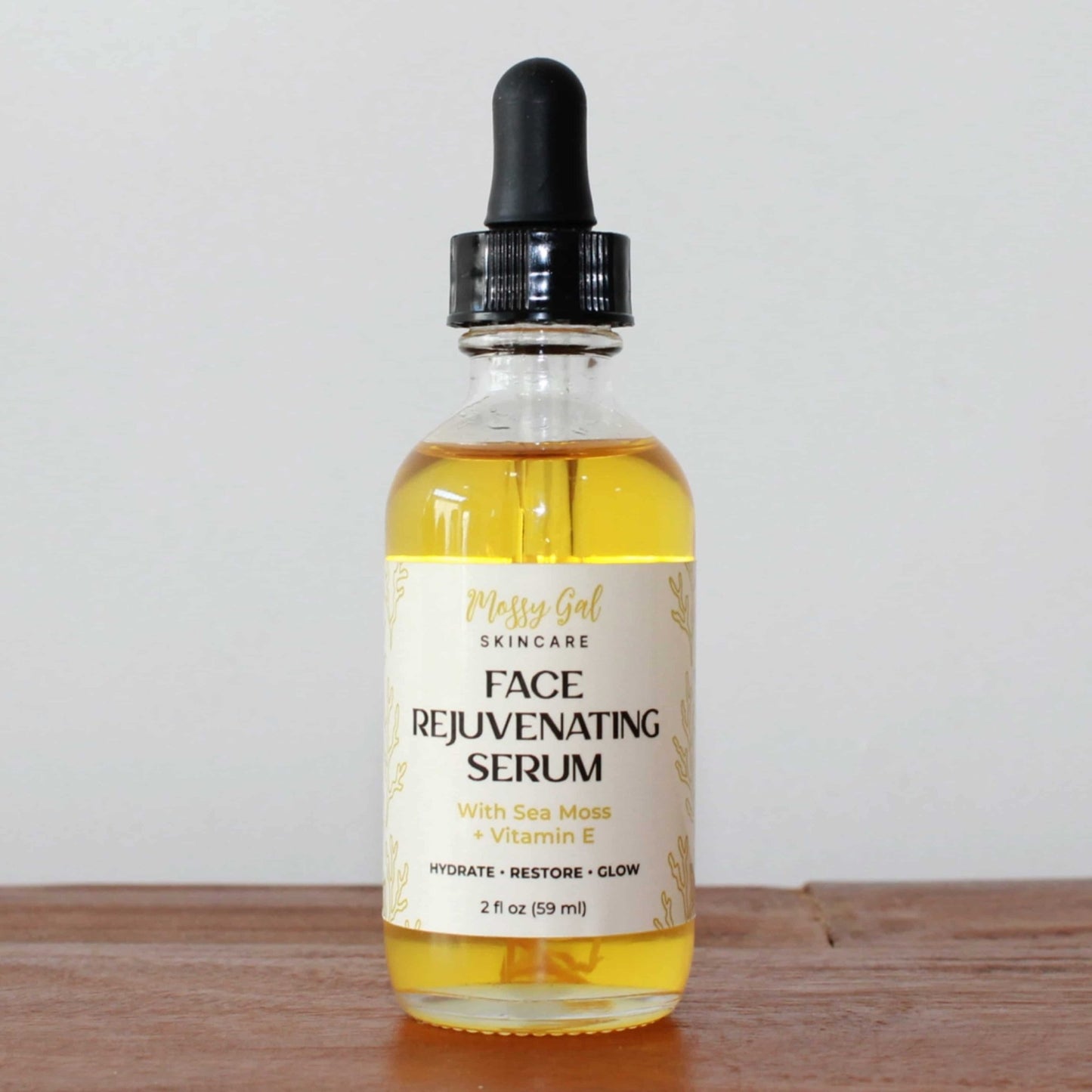Face rejuvenating serum bottle with dropper on a wooden surface