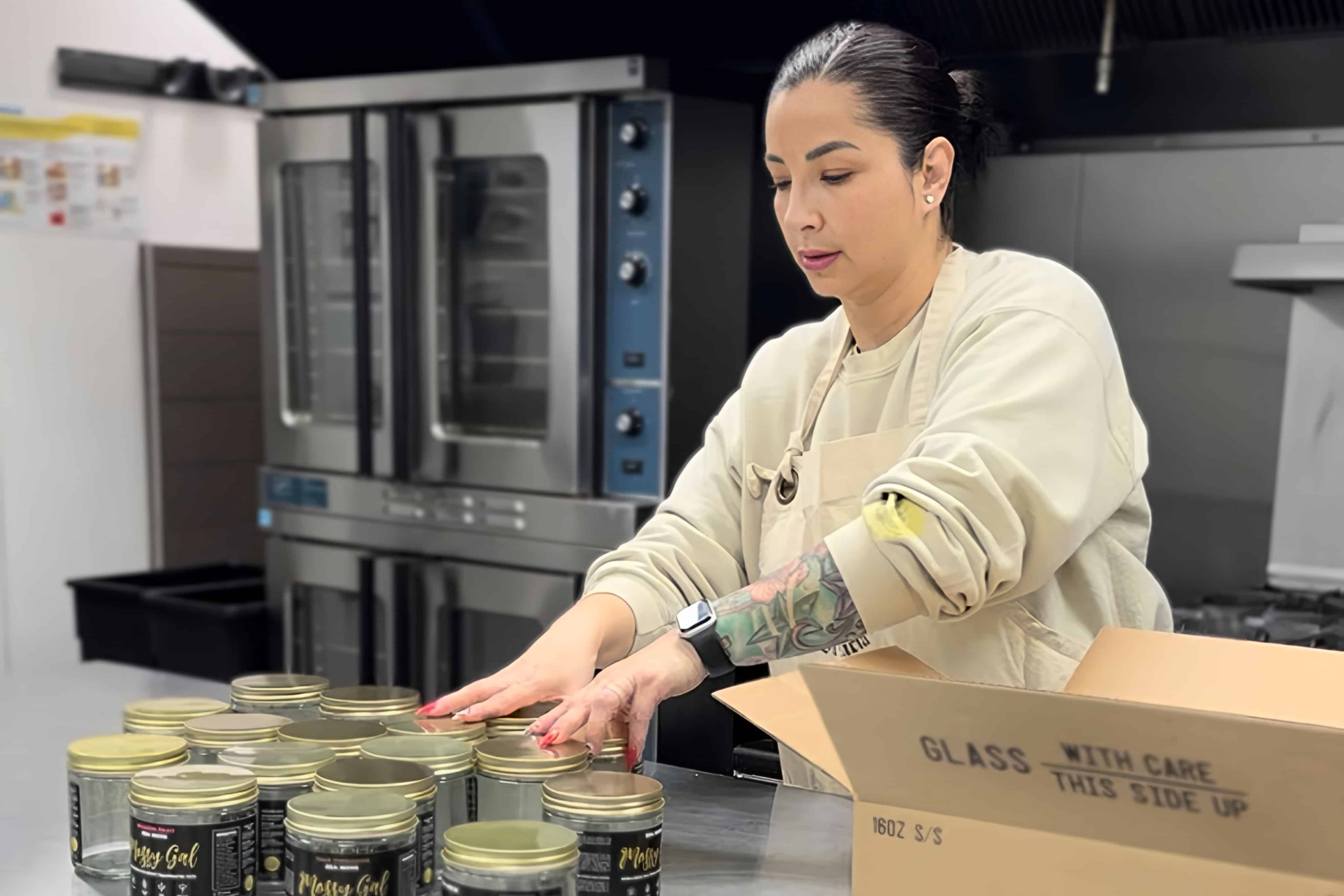 Mossy Gal founder preparing sea moss gel at her workstation with jars and ingredients