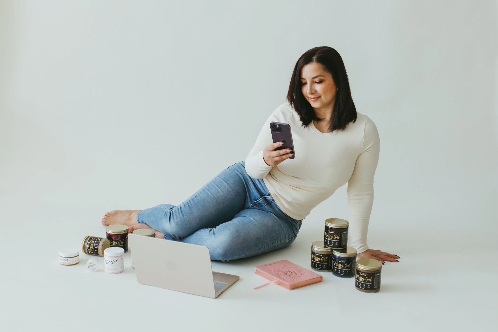 Mossy Gal founder in photography studio with products.