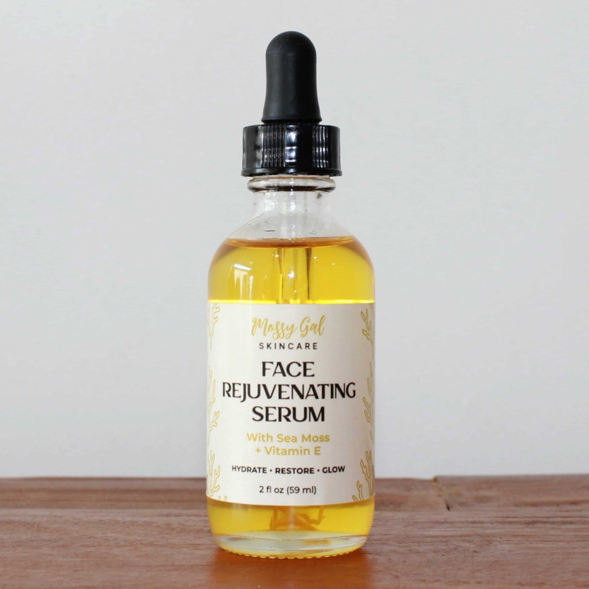 Face rejuvenating serum bottle with dropper on a wooden surface