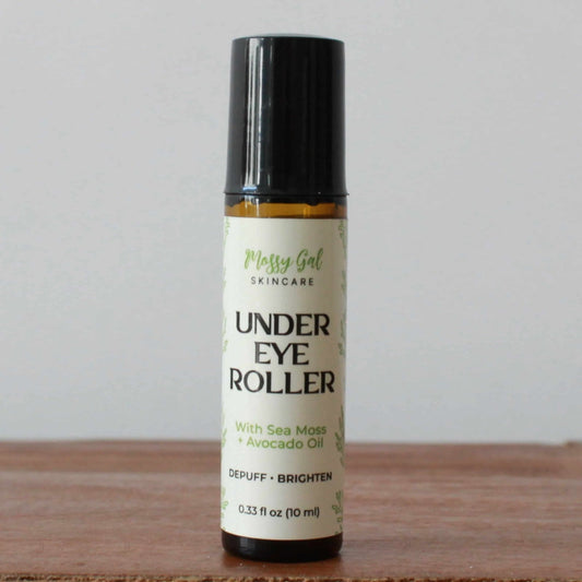 Under eye roller bottle with label on a wooden surface